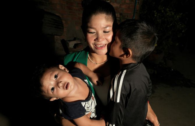 Before going to work, she gets a kiss from her boys. Her mother will take care of them, while she works the night shift.