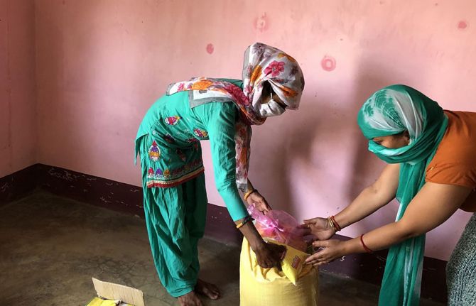 ICWAP staff distributing emergency supplies, including food and sanitary products, to women and girls living with HIV in western Nepal at the beginning of the pandemic in 2020