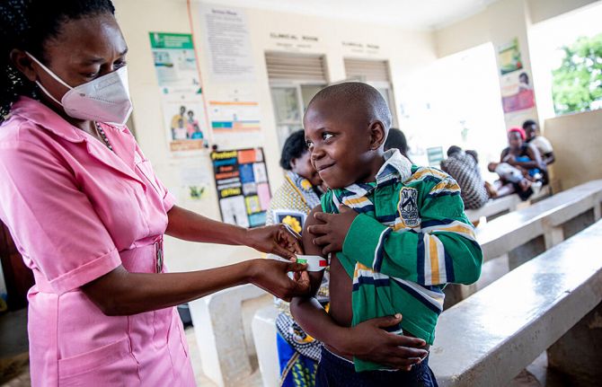 Margret and her son Ronald (9 yrs) attend a health screening at the Madudu Health Facility Mubende, Uganda. Ronald is weighed and his MUAC (measurement of upper arm circumference) is taken. Margret and Ronald are HIV positive and currently on medication. 