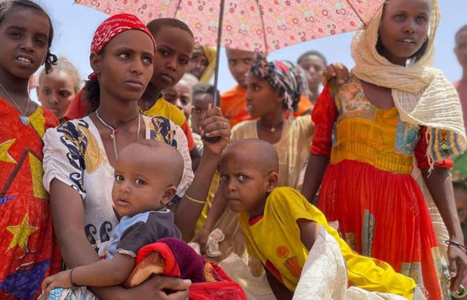 © WFP/Claire Nevill Women and children wait at a food distribution site in Adimehamedey in Tigray, Ethiopia.