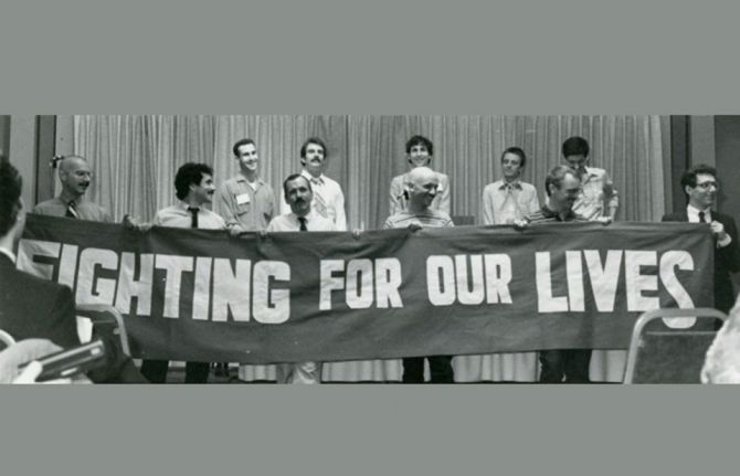 AIDS activists unfurl a banner at the National Lesbian and Gay Health conference in June 1983 in Denver.