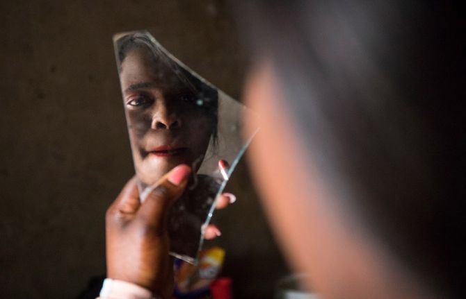 Melody, a sex worker from Epworth, Zimbabwe, prepares herself for work. Melody receives support from Katswe Sistahood, an organization which advocates for women’s full attainment of sexual and reproductive rights in Zimbabwe. Credit: UNAIDS/C. Matonhodze