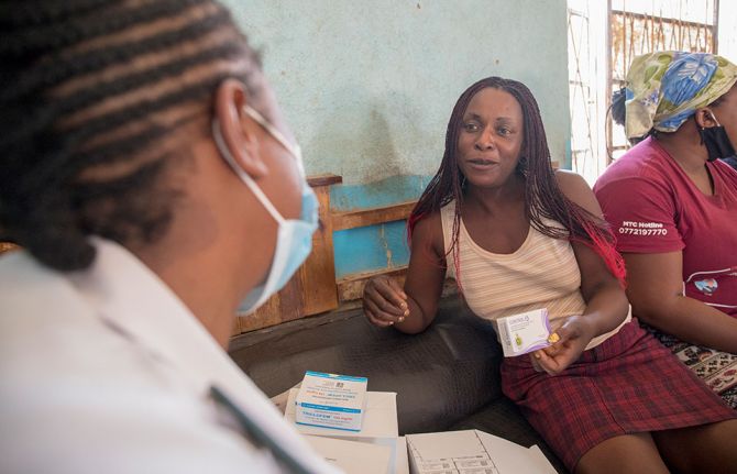 Skyline Kudzuramoto receives birth control pills at a mobile clinic set up at a  night club in Zimbabwe. With the advent of COVID-19, community-based ROOTS has been working to provide access to sexual and reproductive health and rights services as well as