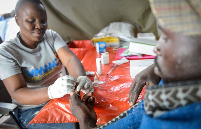 Mmote Mohasi, a voluntary medical male circumcision client, is tested for HIV at a mobile clinic in a remote area outside Braakfontein, Lesotho, before he undergoes voluntary medical male circumcision. 31 October 2019. 