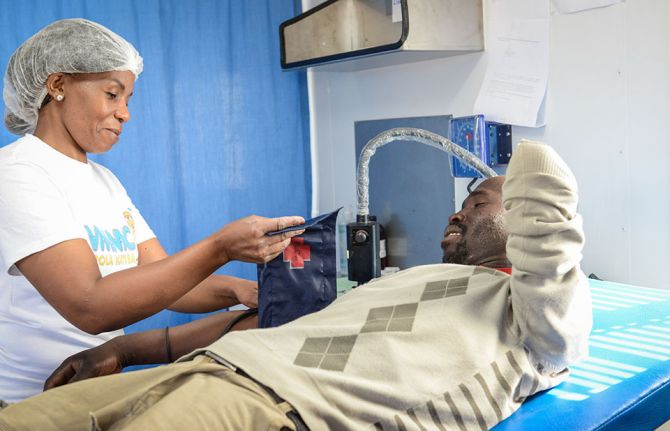 Mmote Mohasi, a voluntary medical male circumcision client, has his blood pressure checked at a mobile clinic in a remote area outside Braakfontein, Lesotho, before he undergoes voluntary medical male circumcision. 31 October 2019. 