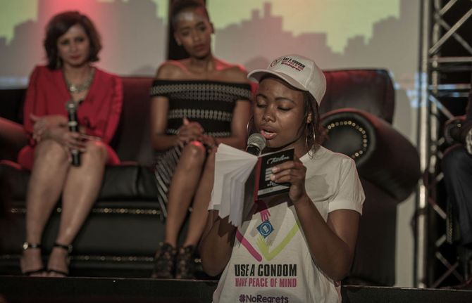 A young woman from the Colour My HIV campaign recites a poem at a Global Citizens event on World AIDS Day 2018.